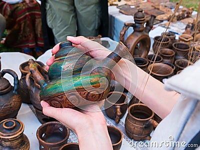 Close up of woman hands with ceramic kettle Editorial Stock Photo