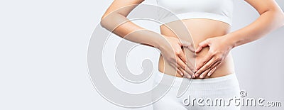 Close up woman hands made heart on belly isolated on white background banner size.health care digesting concept Stock Photo