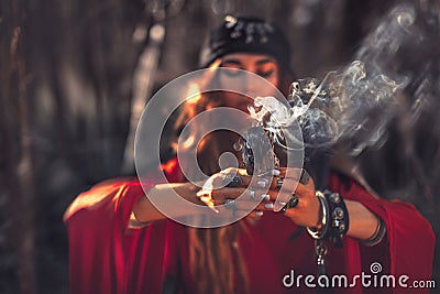 Close up of woman hands with shamanic fire outdoors Stock Photo