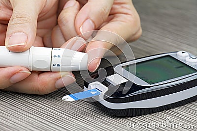 Close-up Of Woman Hands Testing High Blood Sugar With Glucometer. Stock Photo