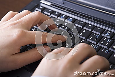 Close up of woman hands typing in the laptop compu Stock Photo