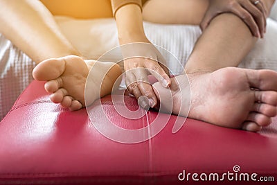 Close up of woman having a heel or foot sole pain,Female feeling exhausted and painful,foot sole massage Stock Photo