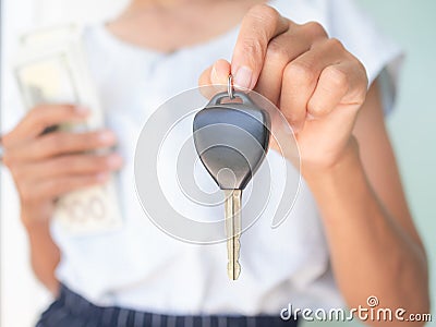 Close up woman holding car keys blur holding bank note Stock Photo