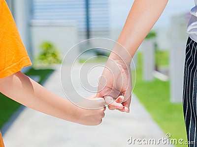 Close up of woman holds the hand of a lovely child. Stock Photo