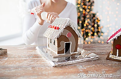 Close up of woman making gingerbread houses Stock Photo