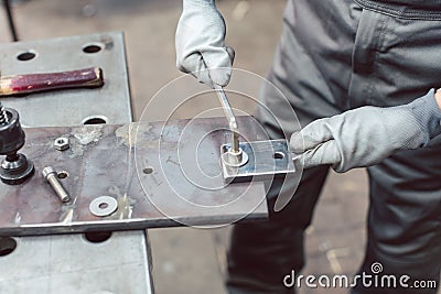 Close-up of woman metalworker in her workshop Stock Photo