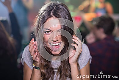 Close-up of woman with mouth open in nightclub Stock Photo