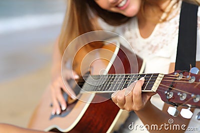 Close up of a woman playing guitar on the beach Stock Photo