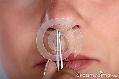 Woman Plucking Her Nose Hair Stock Photo