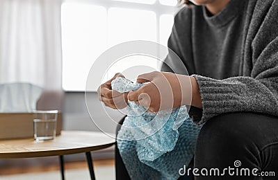 close up of woman popping bubble wrap at home Stock Photo