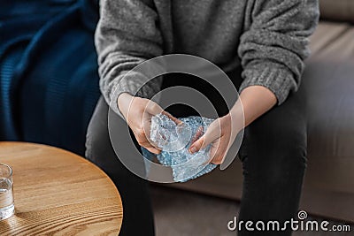 close up of woman popping bubble wrap at home Stock Photo