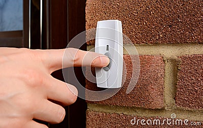 Close-up of woman pressing a doorbell Stock Photo