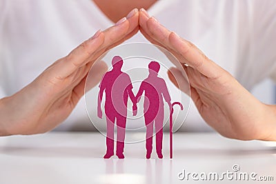 Woman Protecting Senior Couple Cutout Stock Photo