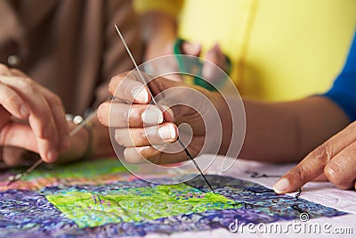 Close Up Of Woman's Hand Sewing Quilt Stock Photo