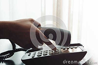 Close-up of Woman`s Hand using a Telephone in House or Hotel nea Stock Photo