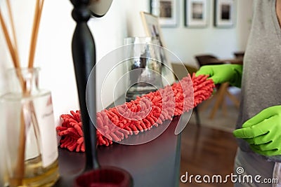 Close-up of a womanâ€™s hand wiping the fireplace at home Stock Photo