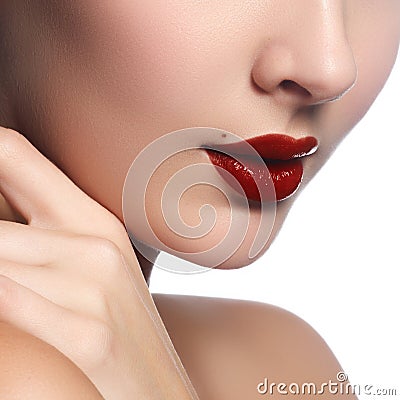 Close-up of woman`s lips with bright fashion dark red glossy mak Stock Photo