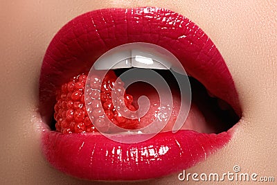 Close-up of woman's lips with bright fashion red glossy makeup Stock Photo