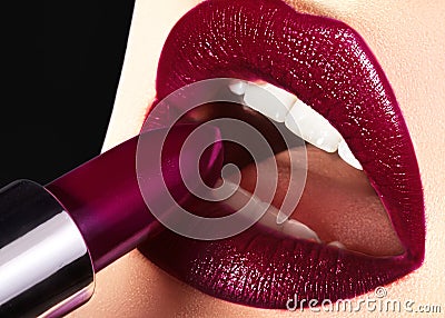 Trend Lips Makeup with bright dark Color Lipstick. Woman Applying Fashion lip Make-up. Choice lipstick Stock Photo