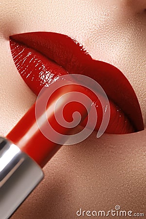 Close-up of woman`s lips with fashion red make-up. Beautiful fem Stock Photo