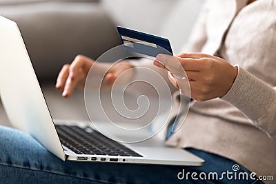 Close up woman shopping, paying by credit card online, using laptop Stock Photo