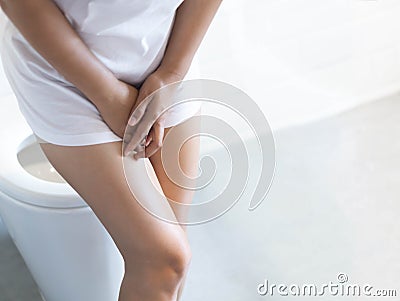 Close up woman stomachache with toilet in the morning, health care concept, selective focus Stock Photo