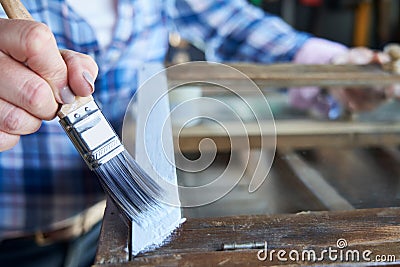 Close Up Of Woman Upcycling Furniture In Workshop At Home Painting Cabinet Stock Photo