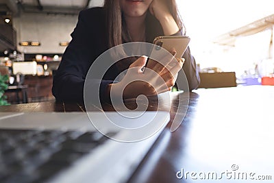 Close up of a woman using mobile smart phone on the table Editorial Stock Photo
