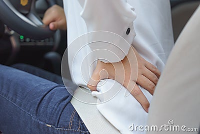 Close up of woman waist with pain - long driving Stock Photo
