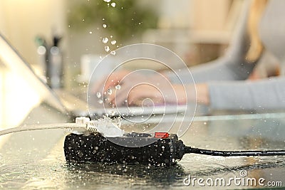 Woman at danger of electrocution for water leaks on socket Stock Photo