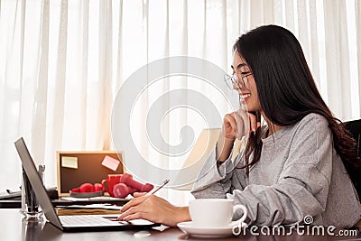 Close up woman is working at home. Freelancer woman is thinking idea for work. work at home concept Stock Photo
