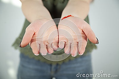 Close up of womans cupped hands showing something Stock Photo