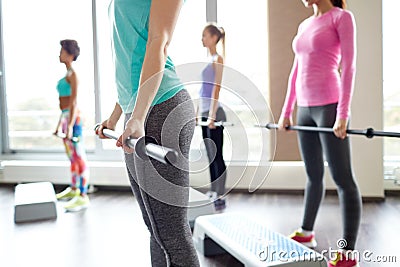 Close up of women exercising with bars in gym Stock Photo