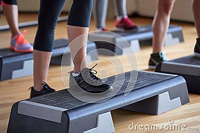 Close up of women exercising with steppers in gym Stock Photo