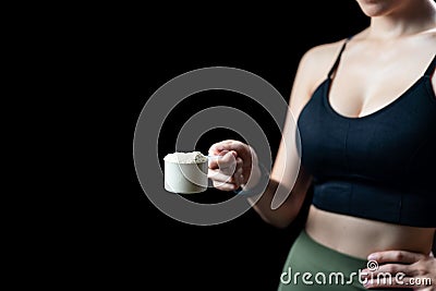 Close up of women hand holding measuring scoop of whey protein preparing protein shake Stock Photo