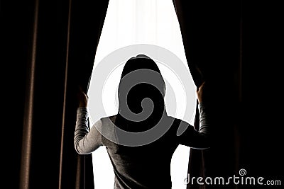 Women opening curtain Stock Photo