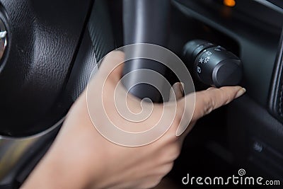 Women`s hand is adjusting headlights Stock Photo