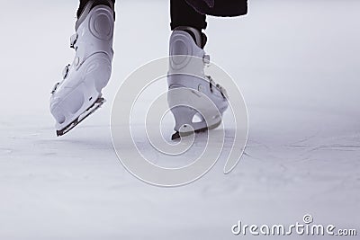 close-up of womens legs on skates in winter on an open skating rink, place for text Stock Photo