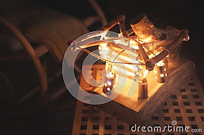 Close-up wooden lampshade with backlight and rocking chair in a poorly lit bedroom at night. Home comfort concept Stock Photo