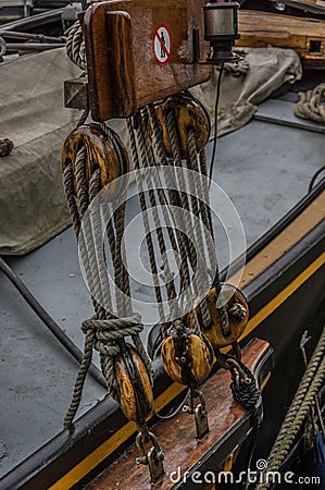 Close up of wooden pully blocks securing the rigging on sail boa Stock Photo