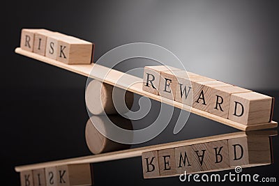 Seesaw Showing Imbalance Between Risk And Reward Stock Photo