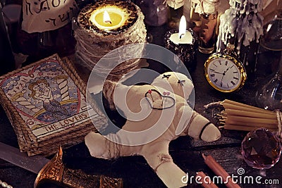 Close up of woodoo doll, knife, burning candles and magic objects Stock Photo