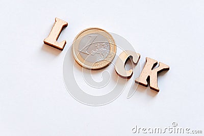 Close-up of the word LOCK composed of wooden letters and coin worth one Euro. Cash accounts in Europe is closed. Savings bank Stock Photo