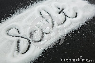 Word Salt on black background written by spilled salt Stock Photo