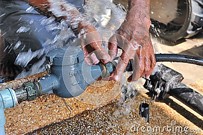 Close-up of worker hands plumbing unscrew connecting pipe while Stock Photo