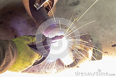 Close-up. Worker weld stainless steel metal products. Establishes a seam Stock Photo