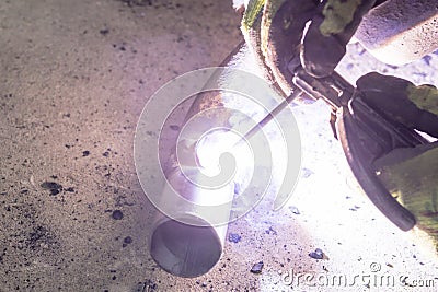 Close-up. Worker weld stainless steel metal products. Establishes a seam Stock Photo