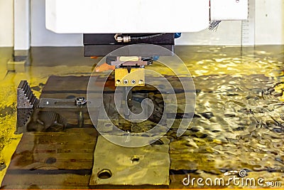 Close up workpiece and graphite electrode during working on automatic electrical discharge machine edm Stock Photo