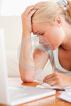 Close up of a Worried blond woman accounting Stock Photo