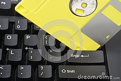 A yellow disket on the enter key pad is concept to warning safe save a datas. Stock Photo